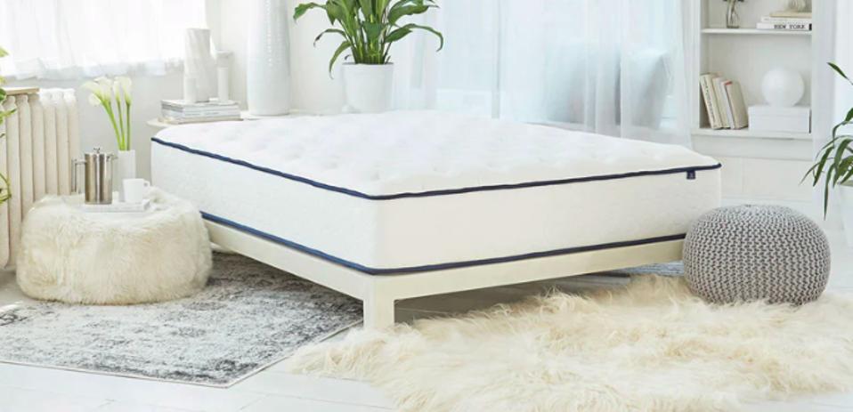 GravityLux Mattress in an airy white room with rugs and windows.